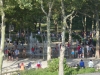 Kids are playing in the fountain on a hot summer day.